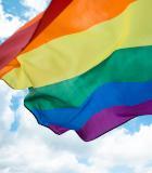 Blue sky behind an LGBTQI+ flag