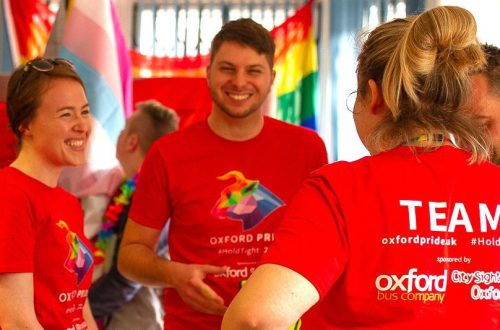 Volunteers smiling at Oxford Pride Day preparations