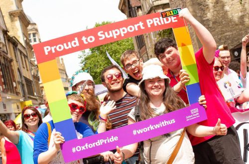 A group you youngsters holding a Proud to Support Pride banner at Oxford Pride